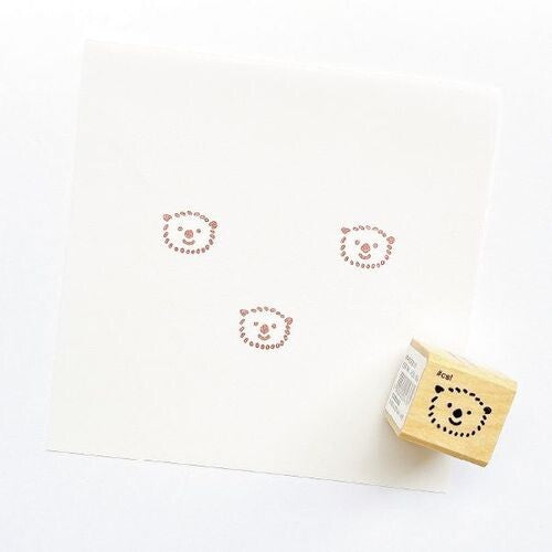 Little Otter Head Rubber Stamp imprint on white paper next to a wooden rubber stamp for stationery use.