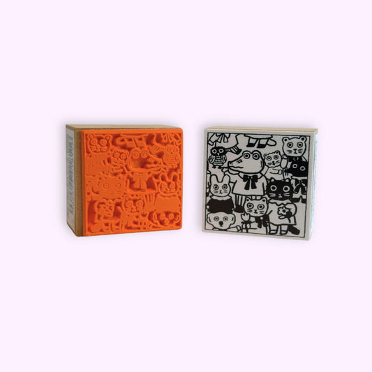 Rubber stamp with assorted animal art by artist Yumi Kitagishi. The front art and the back rubber of the stamp are shown.