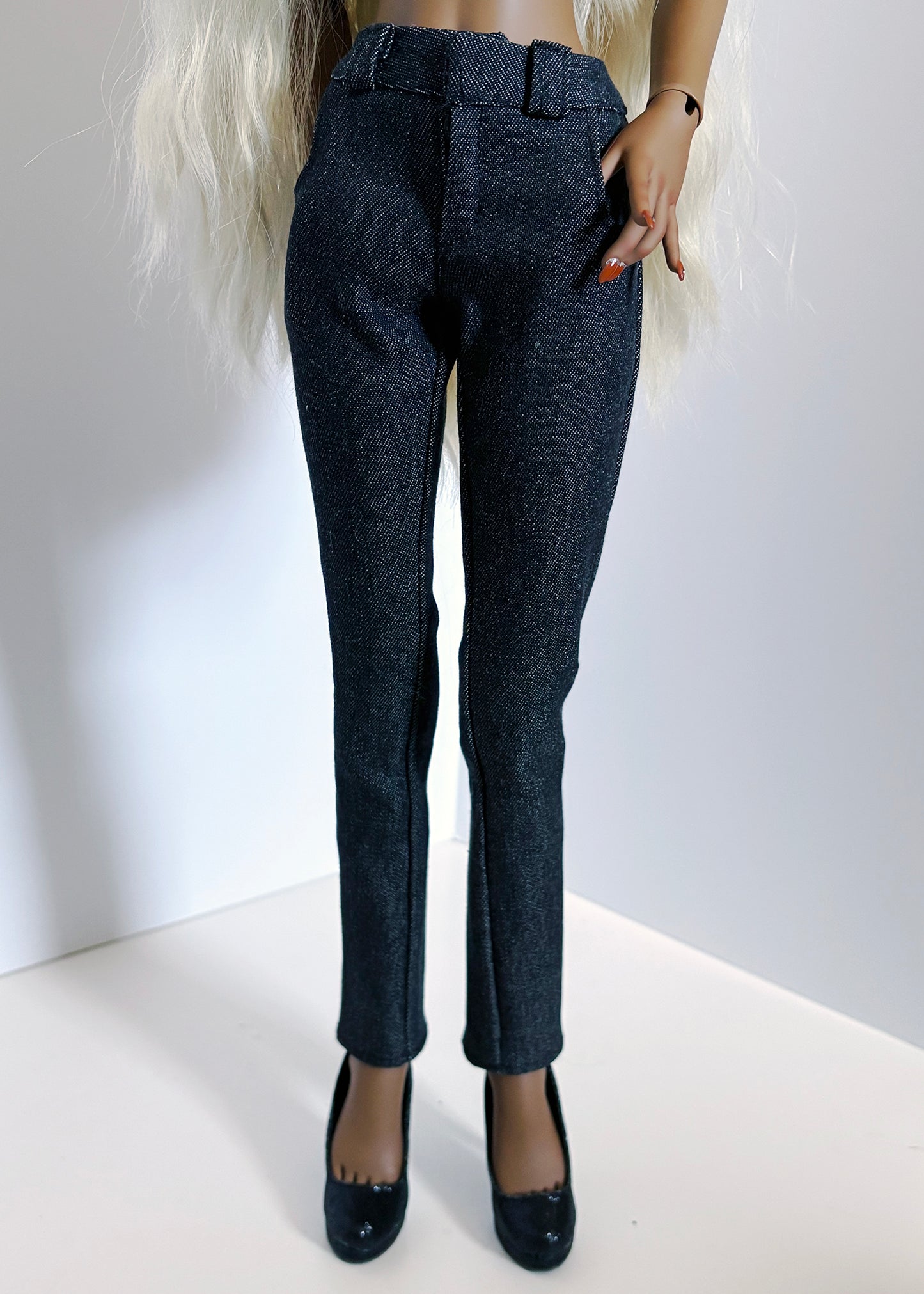 Dark blue pants worn by a person on a white background