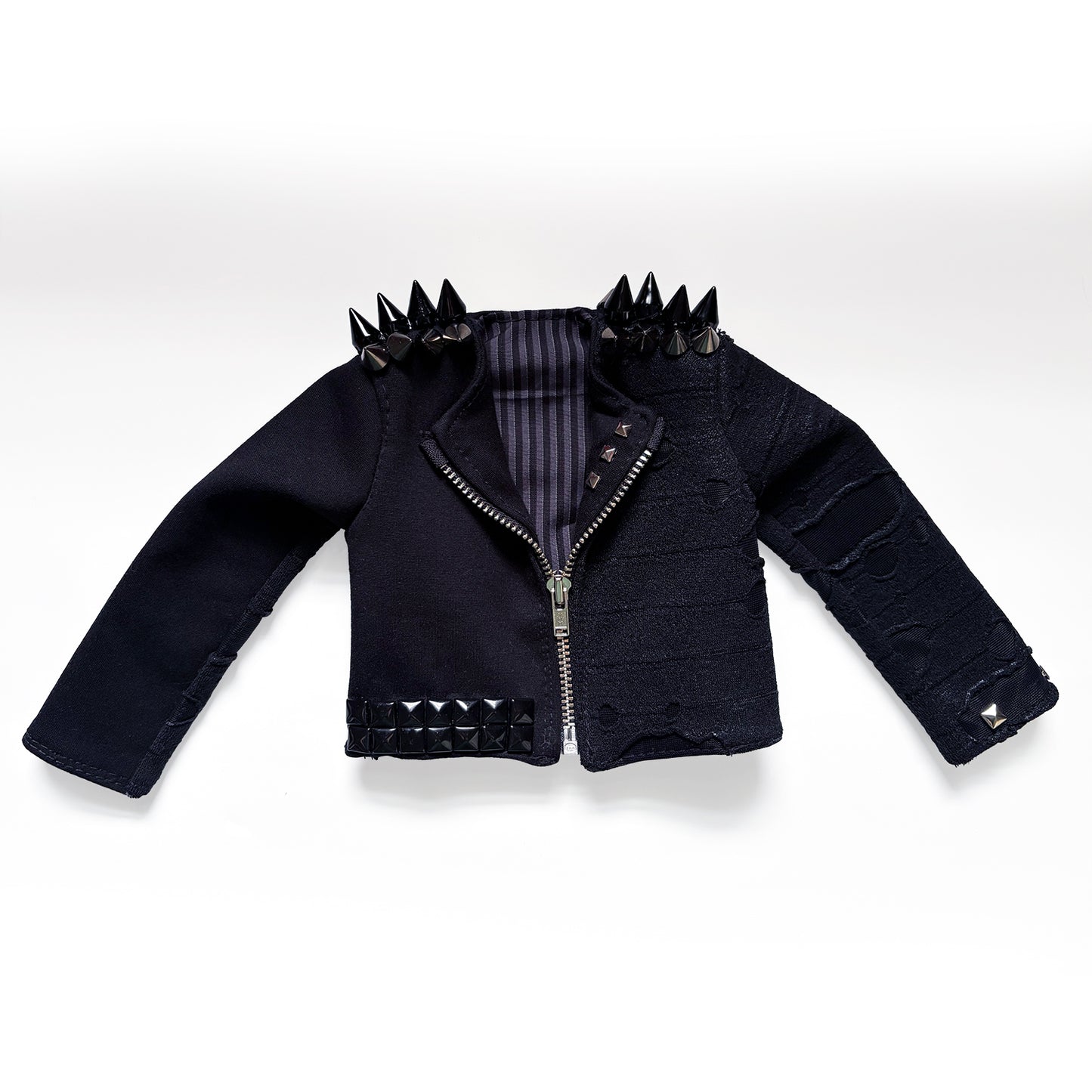 A black goth-style cropped jacket with silver and black studs, spikes, and a striped lining, displayed flat against a white background.