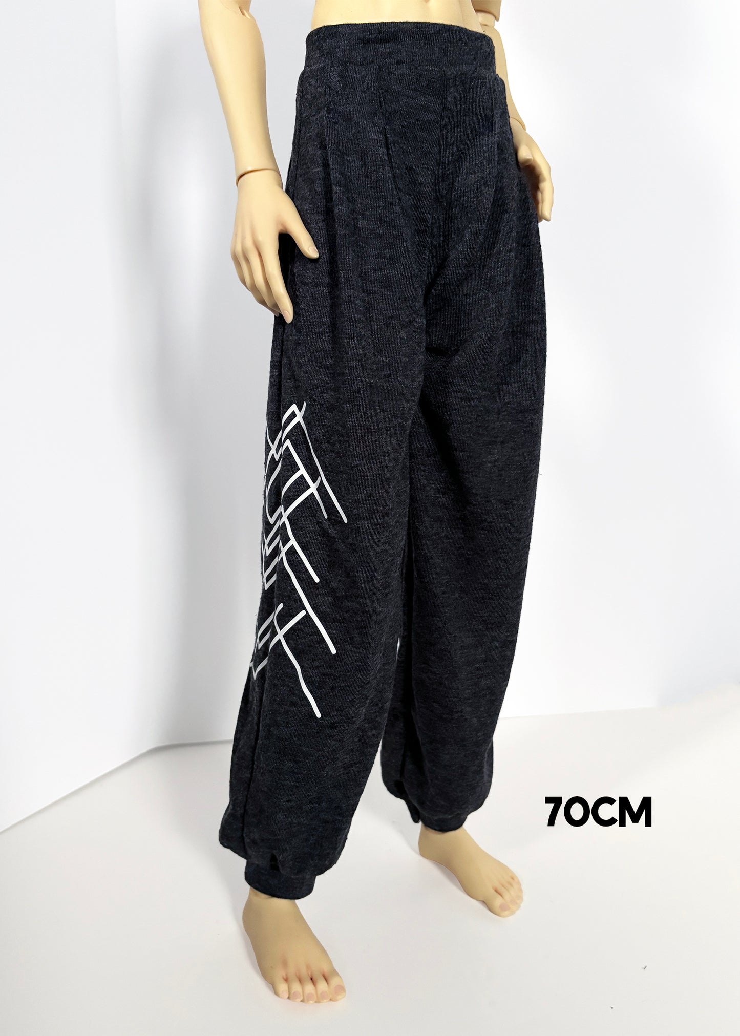 Dark charcoal gray wide-leg sweatpants with a white geometric line pattern on the left leg, displayed on a doll against a white background with a '70CM' text overlay.