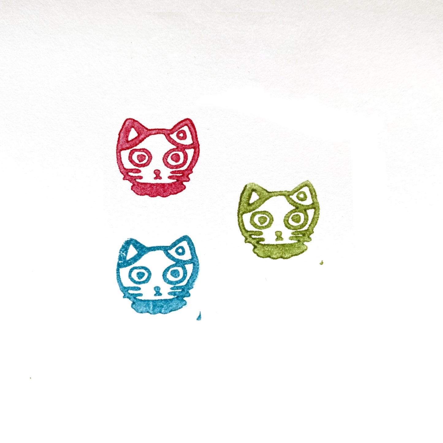 Tiny Calico Mike-chan Cat Head Rubber Stamp impressions in red, green, and blue ink on white paper.