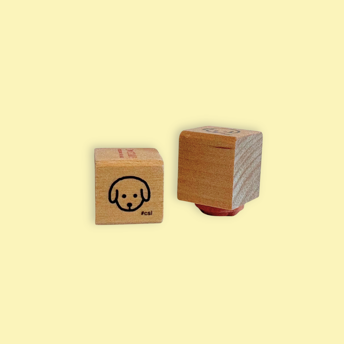 Little Dog Head Rubber Stamp with a simple black dog face design on a wooden block for stationery use