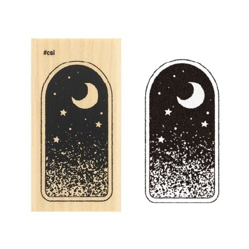 Midnight Sky Window Rubber Stamp showing a crescent moon and stars in a night sky on the wooden stamp block and an example stamped paper.