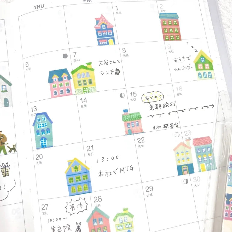 Cute Houses Washi Sticker Roll decorating planner with colorful house stickers on calendar pages.