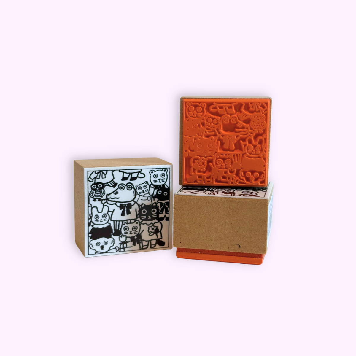 Yumi Kitagishi Animals Rubber Stamp showing cute animal designs on an orange rubber surface on one side and the stamp art on the other side.