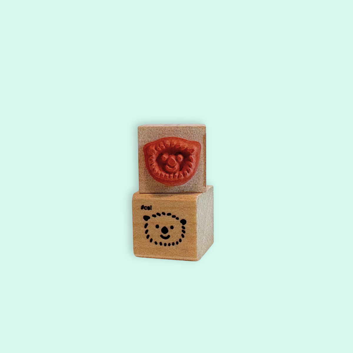 Little Otter Head Rubber Stamp made of wood and red rubber, perfect for stationery and craft projects.