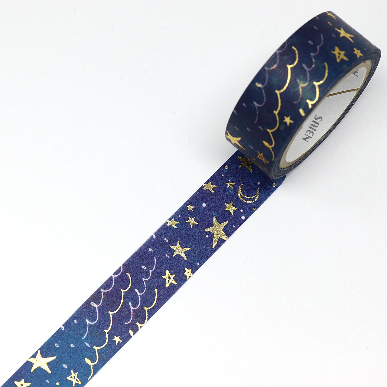 Roll of blue tape with gold star and moon pattern on a white background