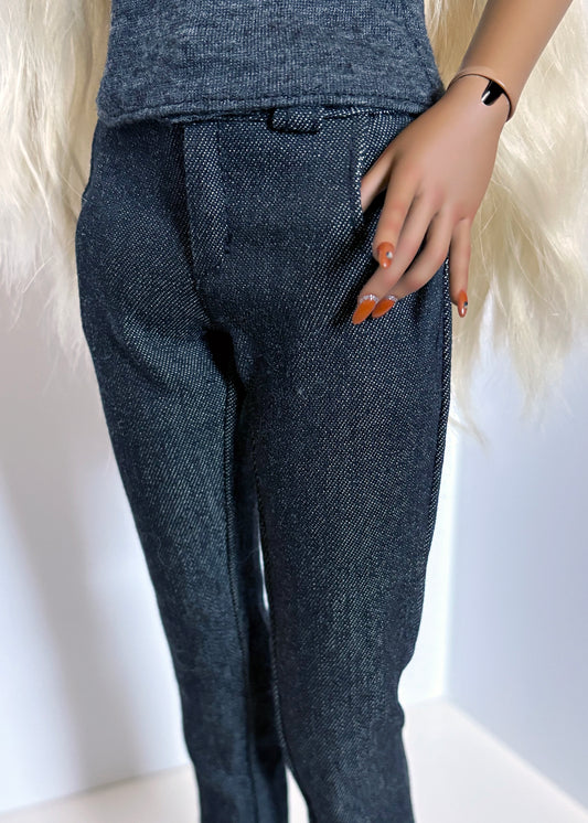 Person wearing dark blue denim pants with a white background