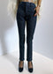 Dark blue pants worn by a person on a white background