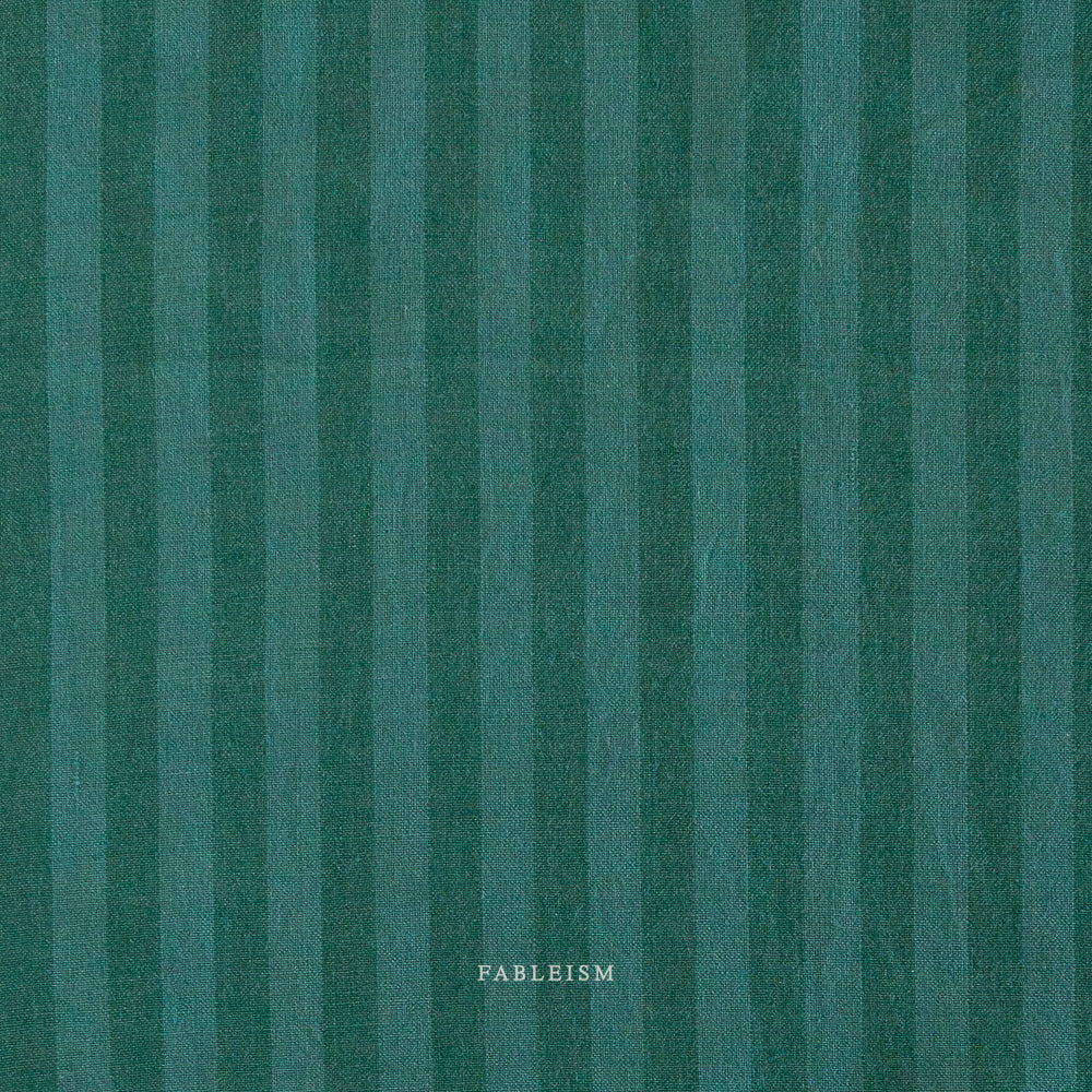 Teal fabric with vertical stripes and 'Fableism' branding.