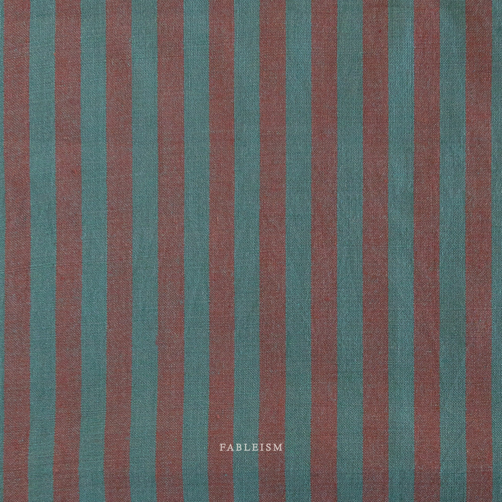Fabric with vertical teal and brown stripes and 'Fableism' branding.