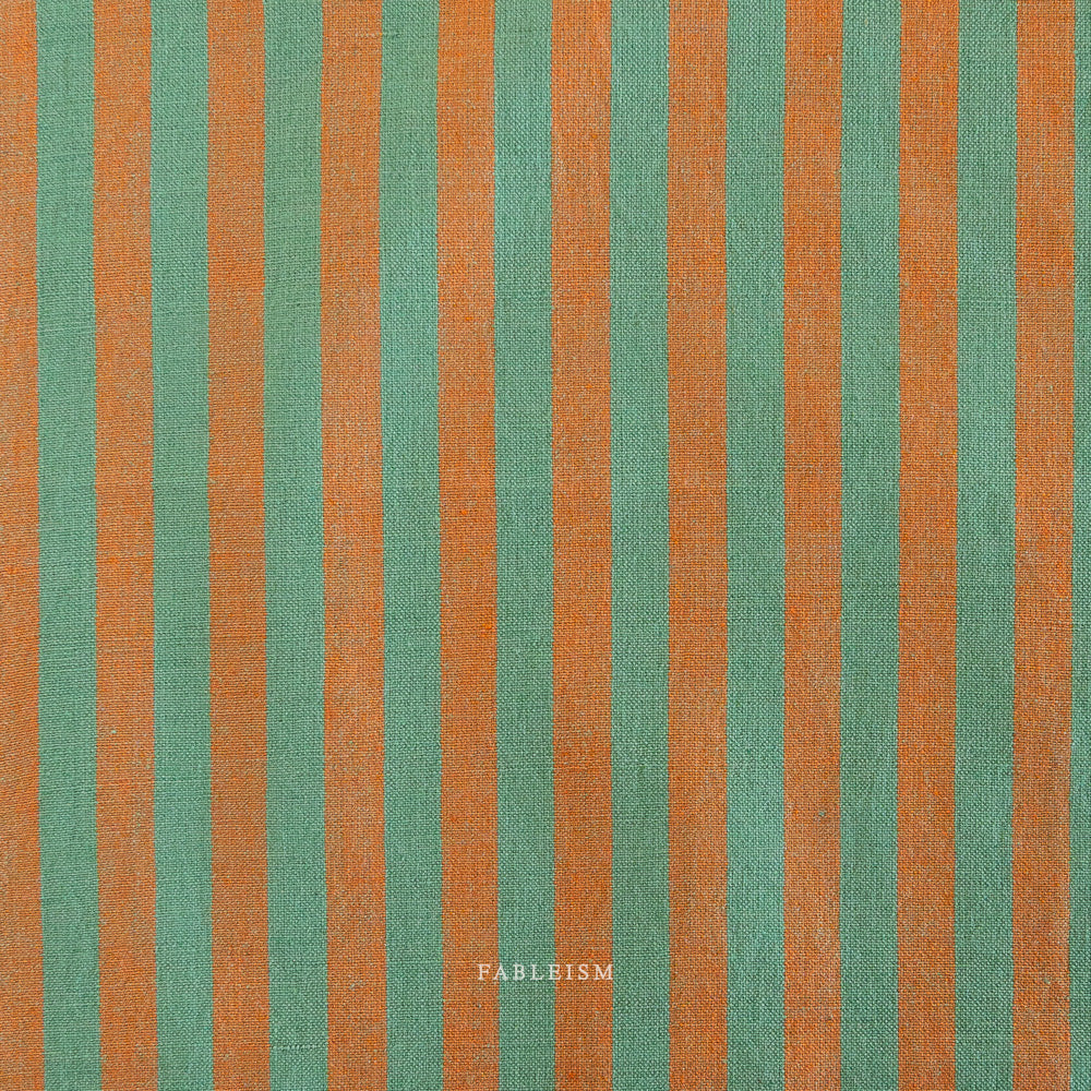 Fabric with green and orange vertical stripes, featuring the brand 'Fableism'.