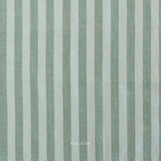 Fabric with vertical light teal and light brown stripes and 'Fableism' branding.