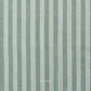 Fabric with vertical light teal and light brown stripes and 'Fableism' branding.