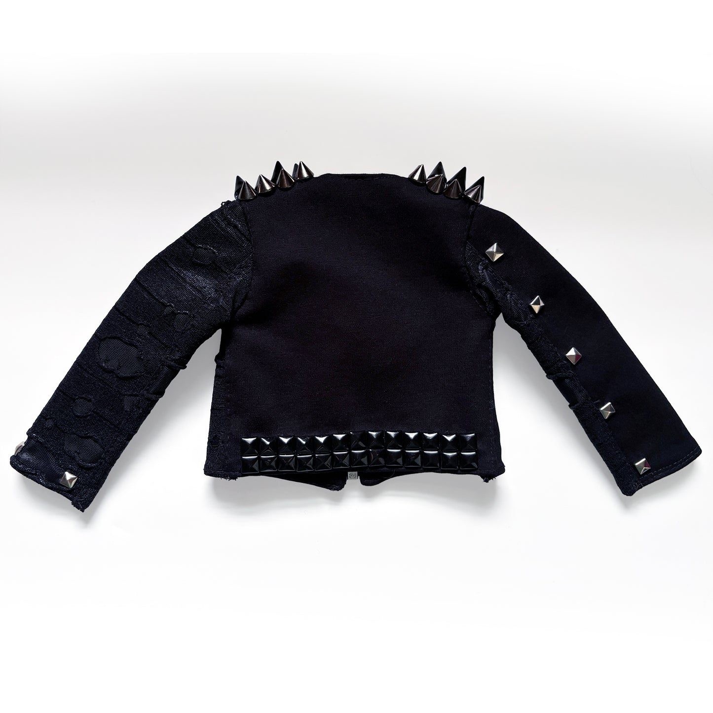 A black goth-style cropped jacket with silver and black studs and spikes, displayed flat against a white background.