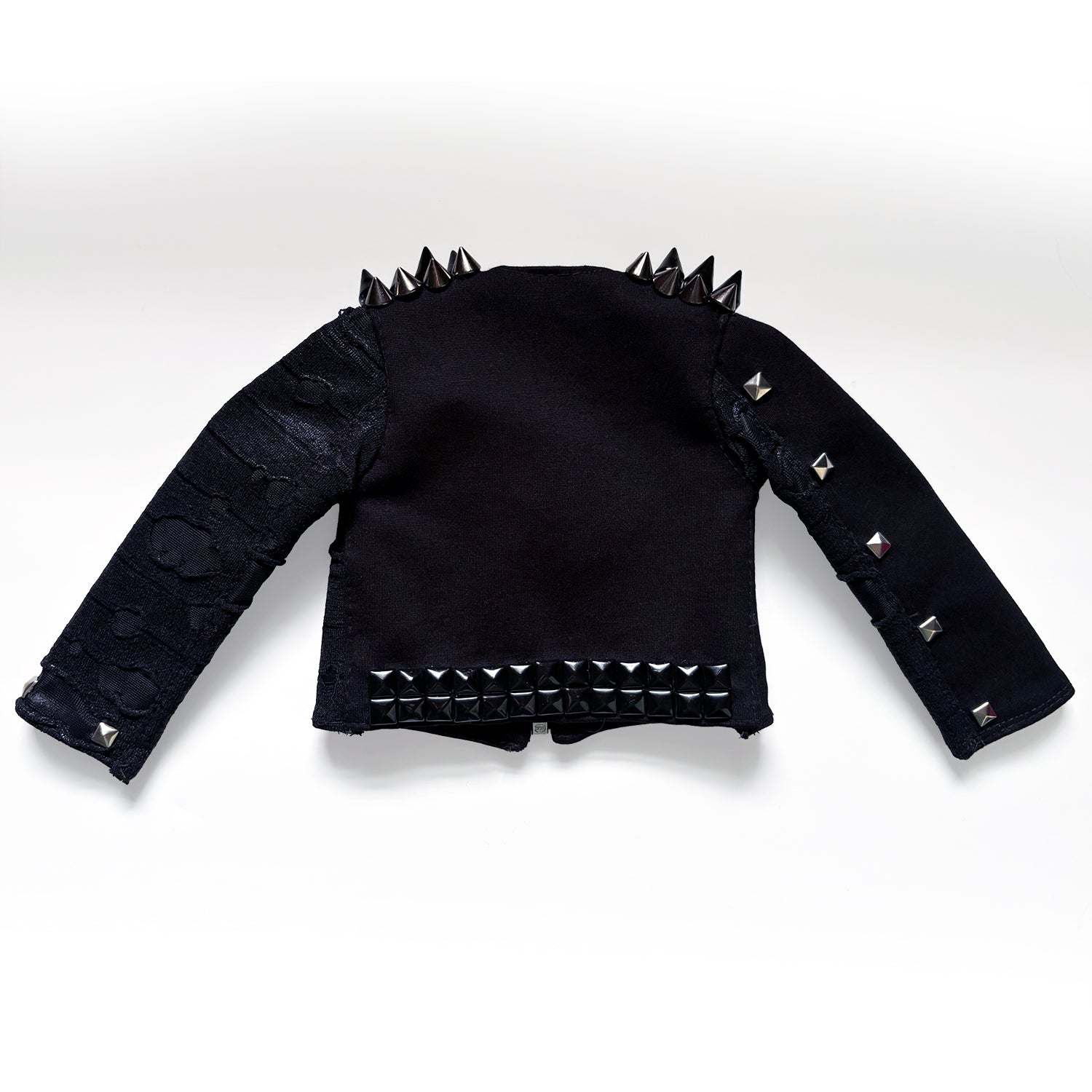 A black goth-style cropped jacket with silver and black studs and spikes, displayed flat against a white background.