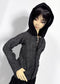 A doll wearing a black hooded zip-up jacket with a textured gray and black wool body, posed against a plain light background.