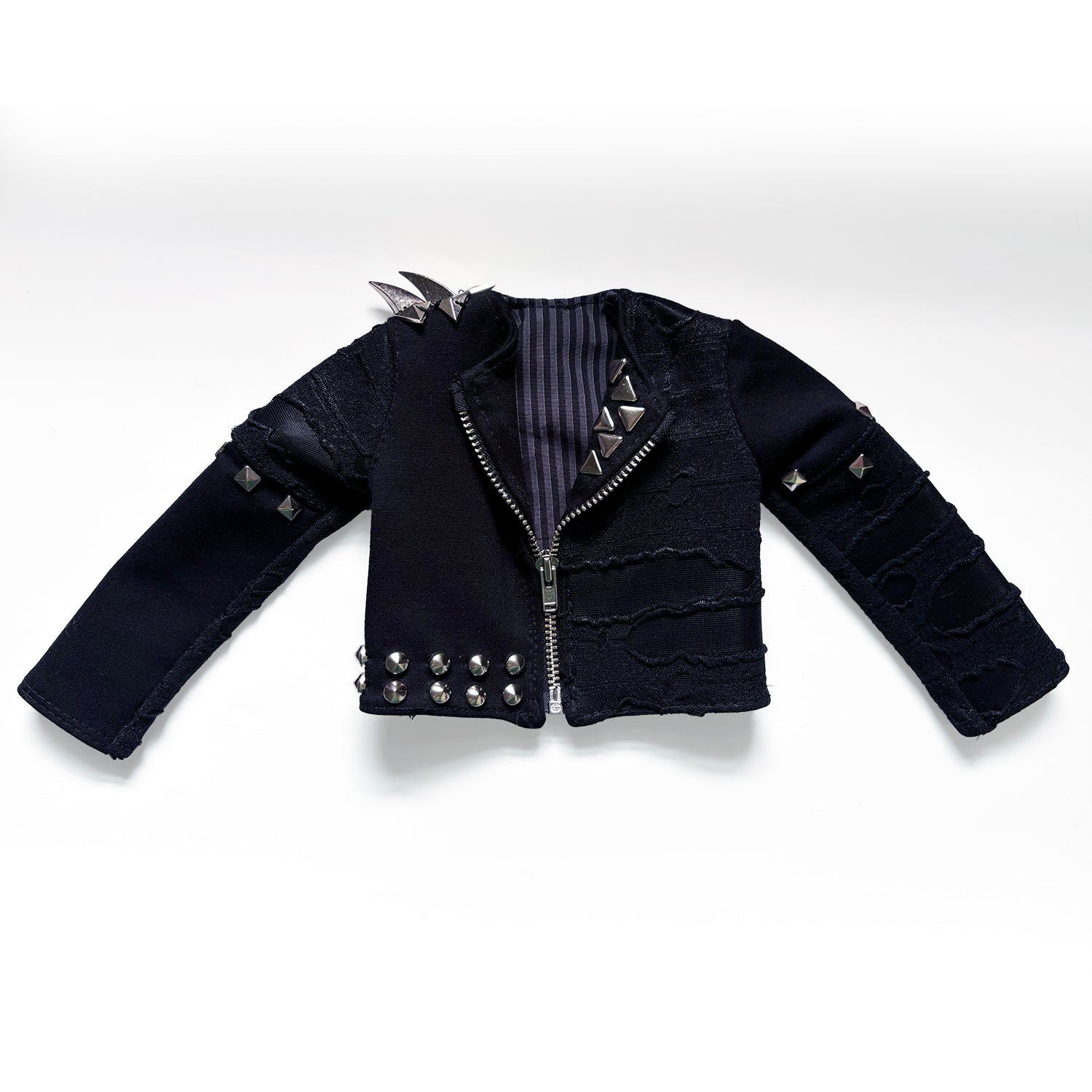 A black goth-style cropped jacket with silver studs, spikes, and a striped lining, displayed flat against a white background.