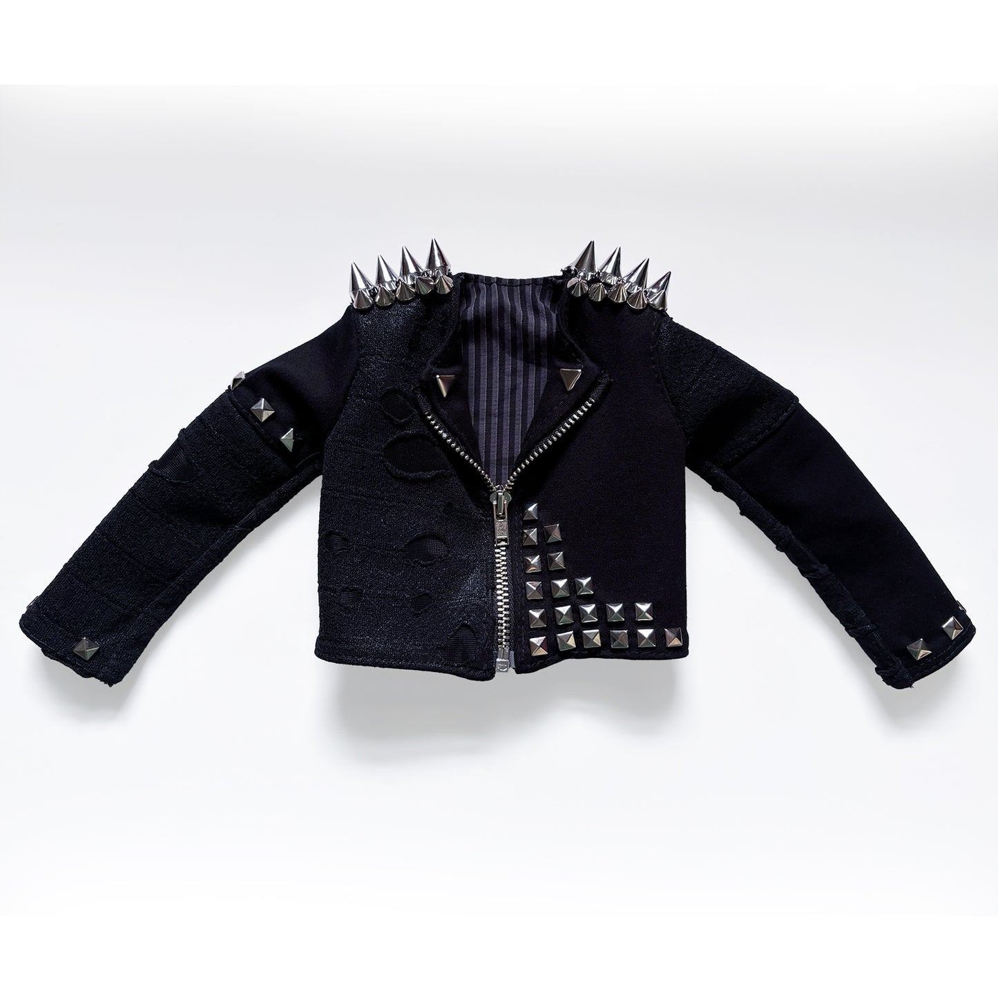 A black studded rock jacket with silver spikes on the shoulders and a striped lining, displayed on a clean white background.