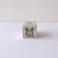 Small cube-shaped stamp with a rabbit design on a white background
