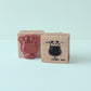 Two wooden stamps with panda illustrations on a light blue background