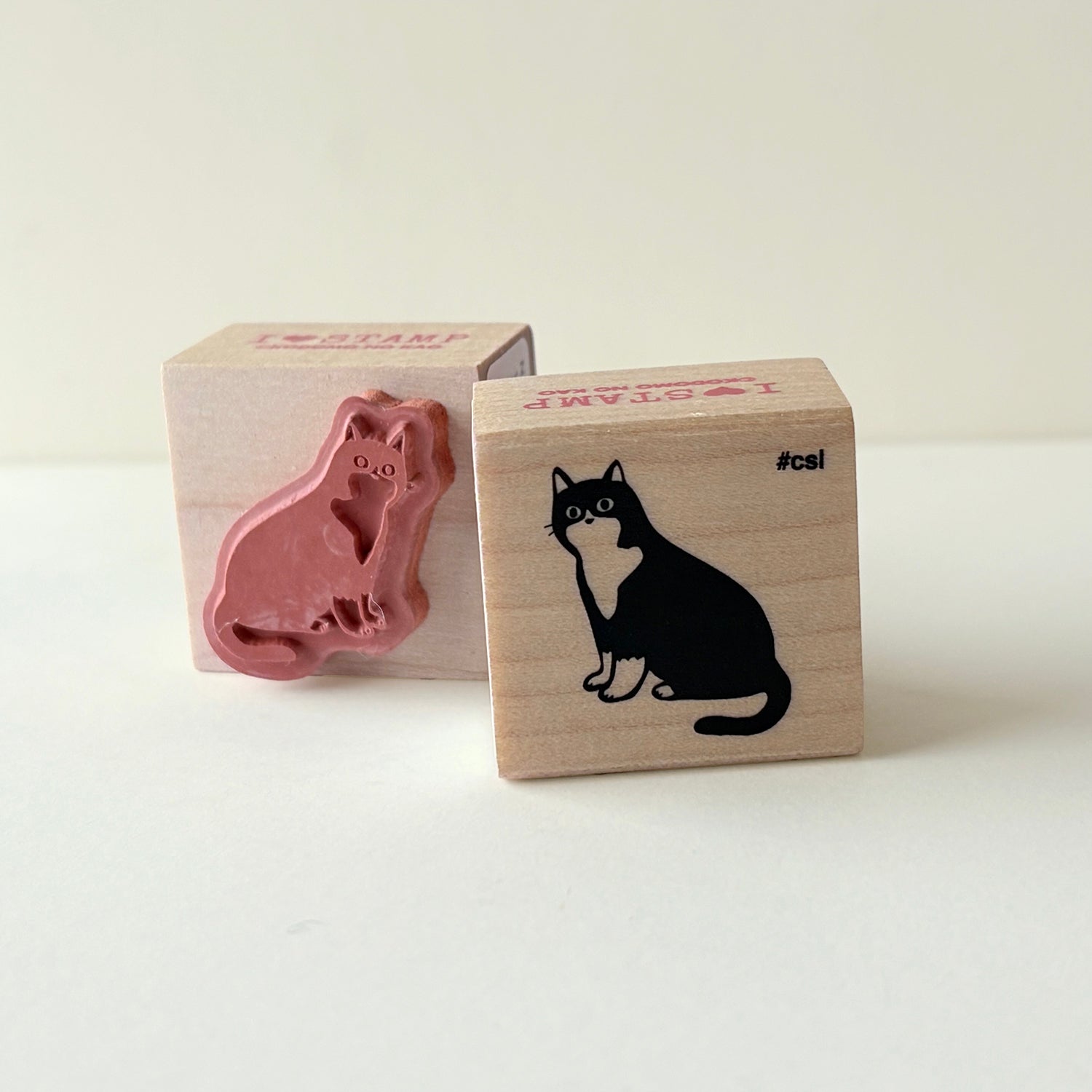 Two rubber stamps with sitting cat designs on a white background