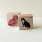 Two rubber stamps with sitting cat designs on a white background