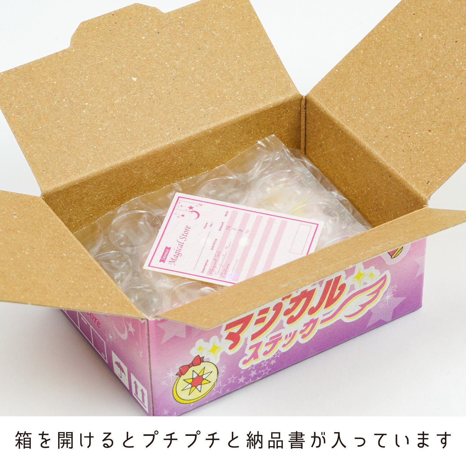 Open cardboard box with a pink product packaging inside, featuring Japanese text.