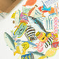Colorful fish-shaped stickers on a white surface