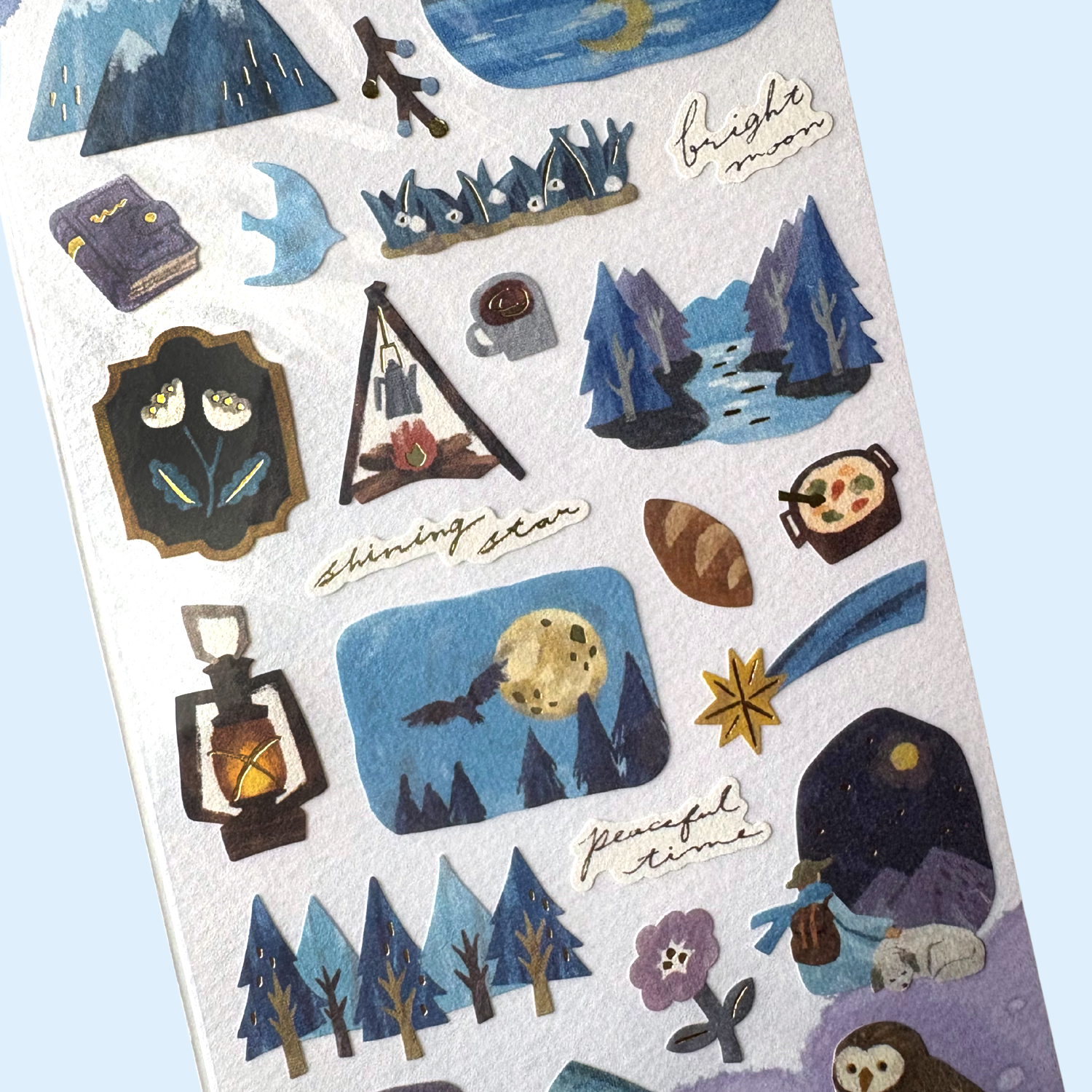 Sheet of winter nature-themed stickers with various illustrations on a light blue background